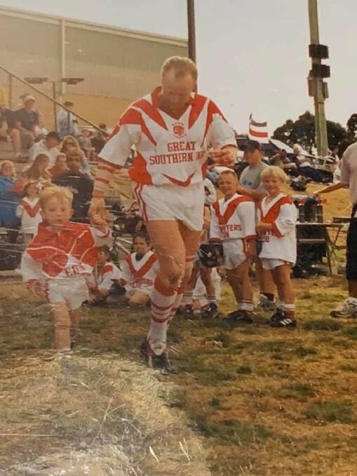 2002 grand final for the Group 16 Rugby League Competition on the Far South Coast of NSW. Neil Baker runs onto the field with his two year old son Harrison. Picture supplied. 