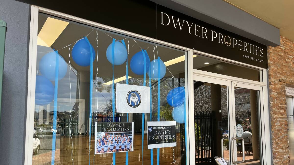 After looking at properties across their windows, clients will see a hosts of Bulldog related items at Dwyer Properties in Merimbula. Picture by James Parker