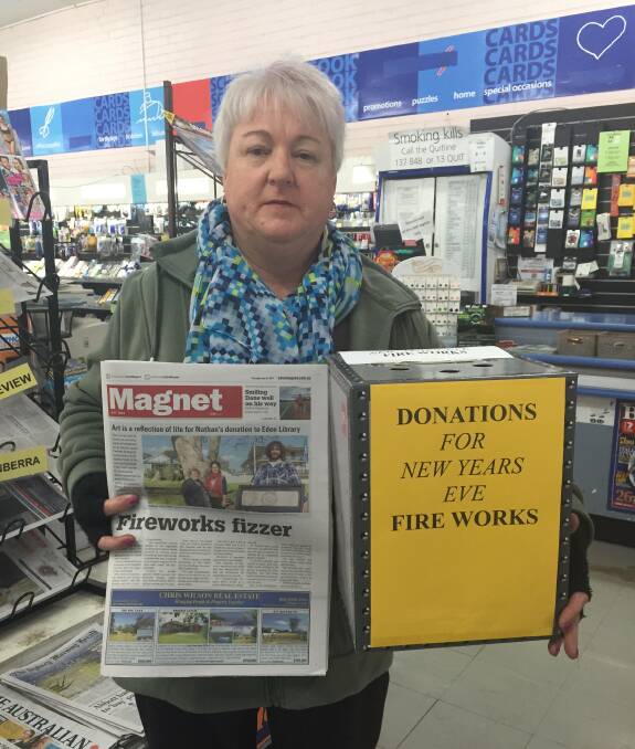 RALLY: Eden newsagent Lynn Slater with the donation box set up to receive money from the community to fund the town's New Year's Eve fireworks display following  council's decision to withdraw its funding. Picture: Liz Tickner