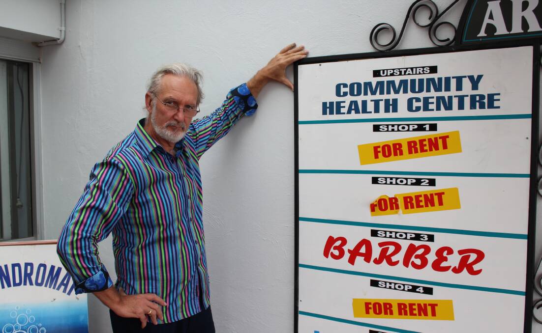 SIGN OF THE TIMES: Eden resident Peter Whiter shows the poor signage, with no mention of the pathology service, at the Community Health Centre. Picture: Toni Houston 