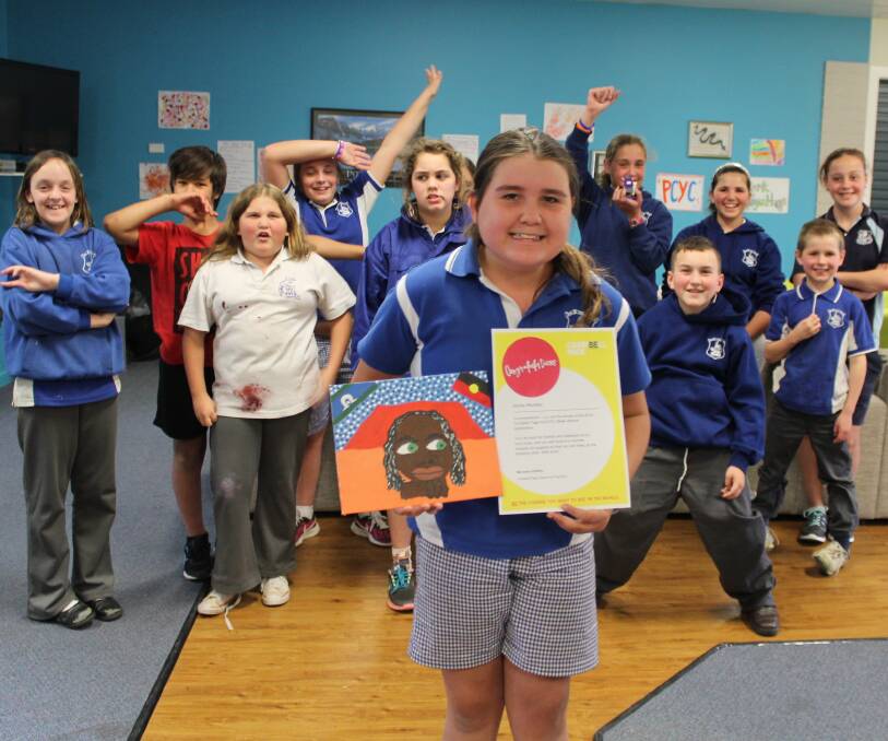WINNER: Jaylay Munday, surrounded by her friends at Campbell Page, has been named the winner of a national indigenous artwork competition. Picture: Liz Tickner