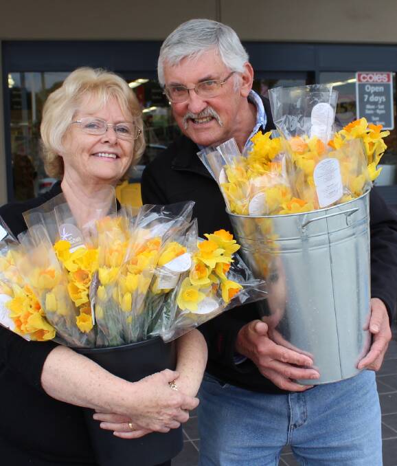 DAFFODIL DAY: Maree and Vic Robinson invite Eden residents to show their support for cancer patients and their loved ones by buying a bunch of daffodils or other merchandise from their stall on Friday. Picture: Liz Tickner