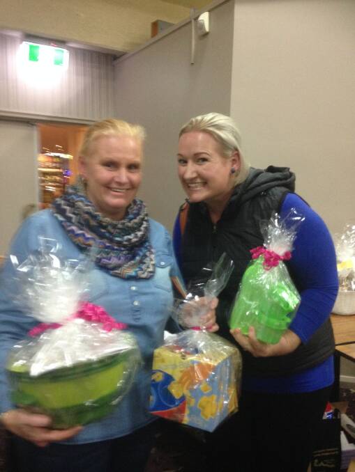 Nicole Brown and Tasha Best with their winnings from a Tupperware raffle.