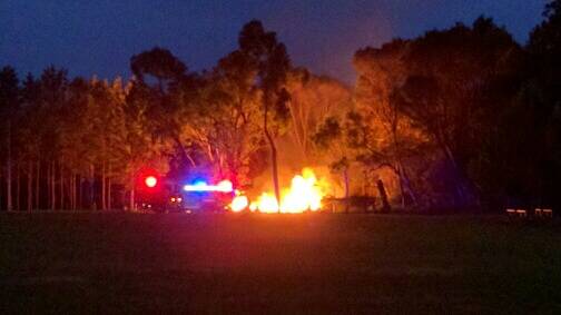 NIGHT BLAZE: A rubbish fire near the Eden Marine High School oval on Wednesday night is quickly attended to by authorities. Picture: Supplied