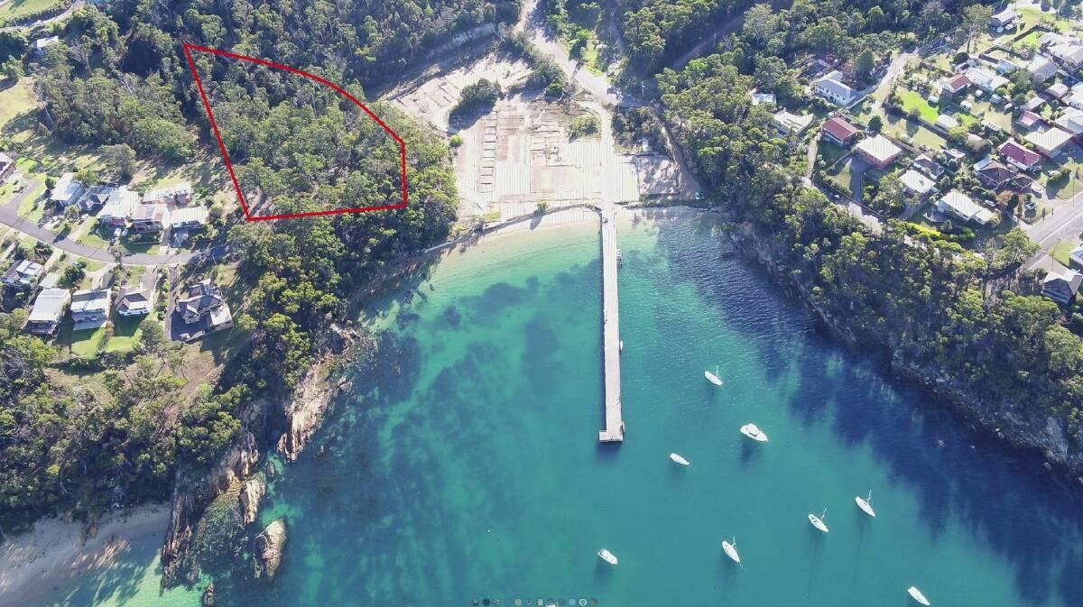The portion of the Cattle Bay Marina (marked in red) site that is for sale alongside a view of the main area, also for sale. 