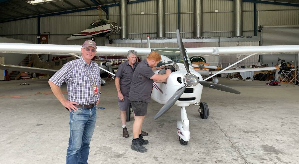 Pilot Peter Davis at Merimbula Aircraft Maintenance with Rex Koerbin and apprentice Tom Burn. Picture by Denise Dion
