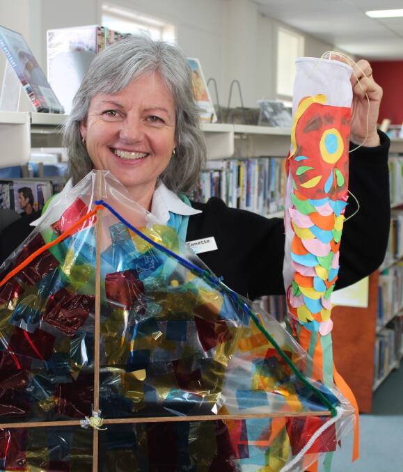 Holiday fun: Eden librarian Zanette Burr holding up prototype kites that children will be helped to make at the library during the school holiday program, Tuesday September 20. Picture: Toni Houston