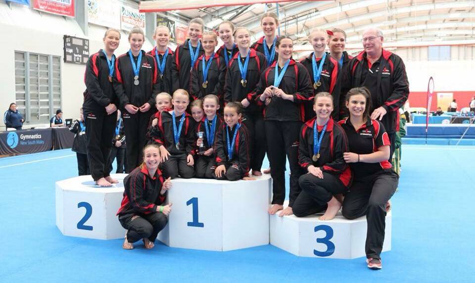 Winning smiles: The acrobats of the Eden Area Gymnastics' club fill the podium after winning gold, silver and bronze in their category, earning enough points for the club to be declared overall winner in the acrobatics' category.