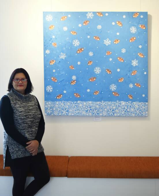Artist and AECG mentor Pauline Coxon with an artwork inspired by the Bundian Way, of bogong moths and snowflakes. Picture courtesy John Blay