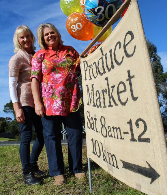 Food for thought: Nethercote Market Incorporated volunteer Birgit Williamson (left) and president Amanda Stroud with a market sign near the Nethercote Rd turnoff outside of Eden, Tuesday July 19. Picture: Toni Houston