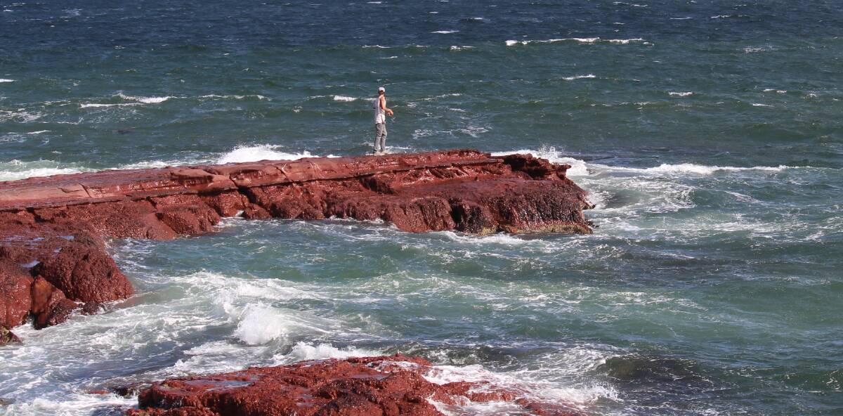 Soon a rare sight: A rock fisher surrounded by open sea near Merimbula Wharf, without the protection of a life-vest. Picture: Denise Dion