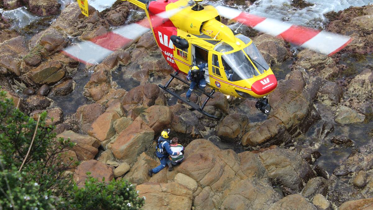 Police, ambulance, SES and Fire Rescue officers converge on Bramble Street clifftop, Eden, at midday on Tuesday October 27 to conduct dramatic rescue of man and dog.