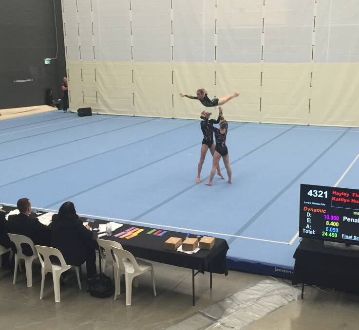 Flying high: level five trio of Eden's Montana Tinson, with Pipi Keogh and Kirra Turner, wow the judges during one of their two qualifying routines, trying-out for the NSW State Gymnastic Championship last Sunday.