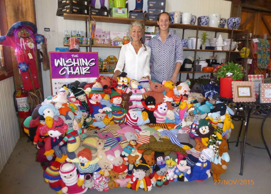 Wishing chair: Artisan Liz McLeod with Oaklands Event Centre gift shop manager Emma Moffitt with the "wishing chair" crafted out of op' shop toys raising money for the new Bega Hospital. Photo courtesy Liz McLeod.