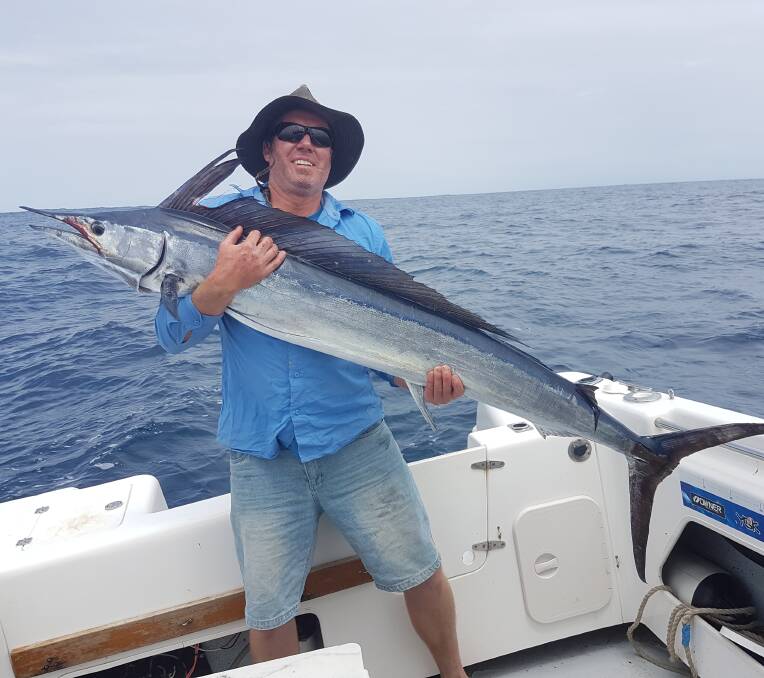 Jason Suter of Wolumla holds his shortbill spearfish that was tagged and released from the boat White Knight.  