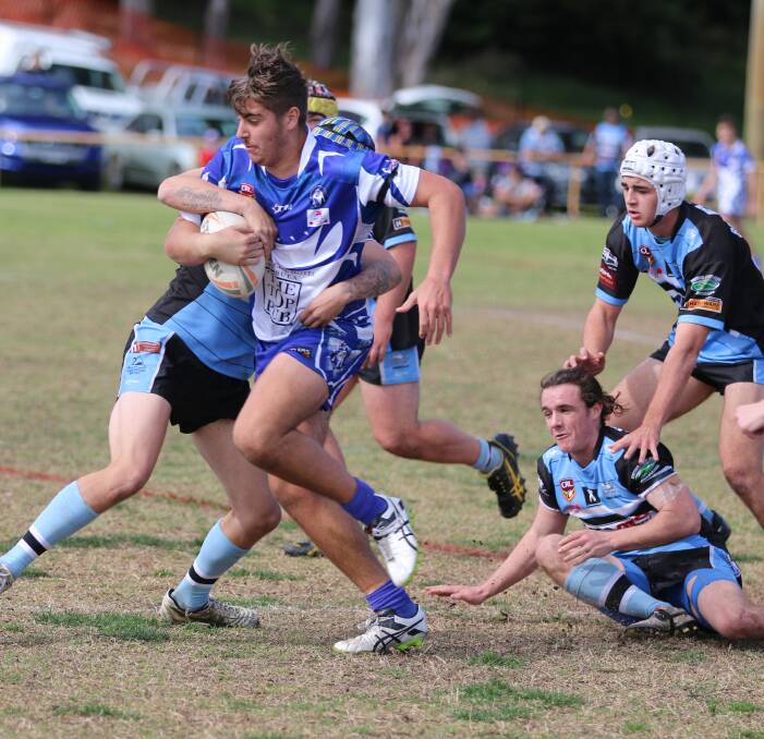 Hard runner: Rueben Smahel lunges through the Moruya line in a strong showing for the Merimbula-Pambula Bulldogs.