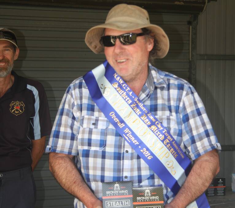 Southern Zone mixed target champion Chris Rowland accepts his sash and prize after a flawless finish to the contest. 