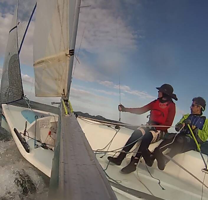 Onboard: Luca Dorrough and skipper Tony Hastings cut through ocean swells while racing at Batemans Bay on the weekend. 