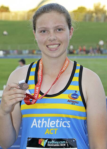 On track: Kiarna accepts the bronze at the Australian Junior Athletics Championships recently and there are ongoing fundraising efforts for her to compete in Canada.