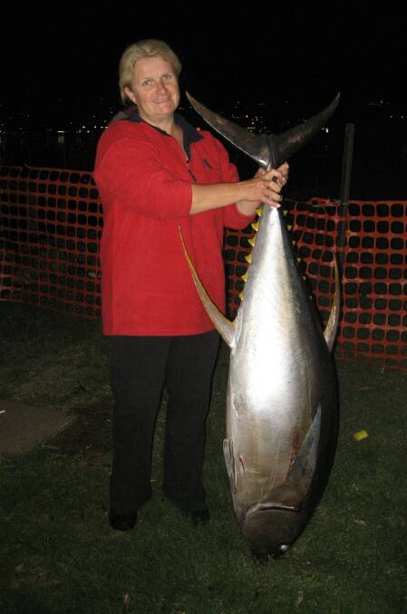 Tournament topper: Janet Chippindale shows her prize-winning Yellowfin Tuna at last year's Merimbula Open Fishing Tournament.