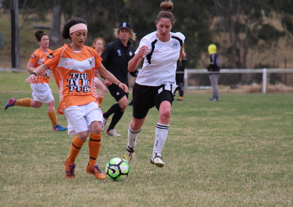 Backline: Eden defender Kim Peters closes in on Pambula's Annalisse Reed during the major semi-final in Wolumla with the two clubs meeting in the grand final on Sunday. 