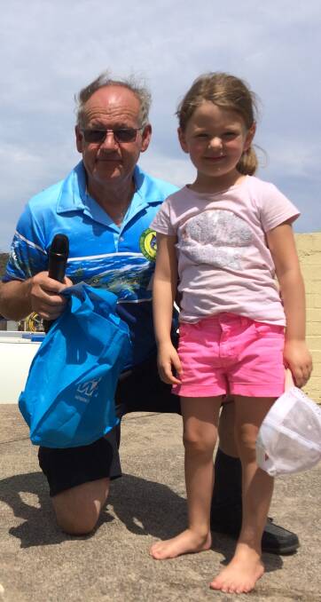 Little tacker: Junior angler Lila DeSantis receives a gala prize for her bag of estuary fish from MBGALAC president John McKay.