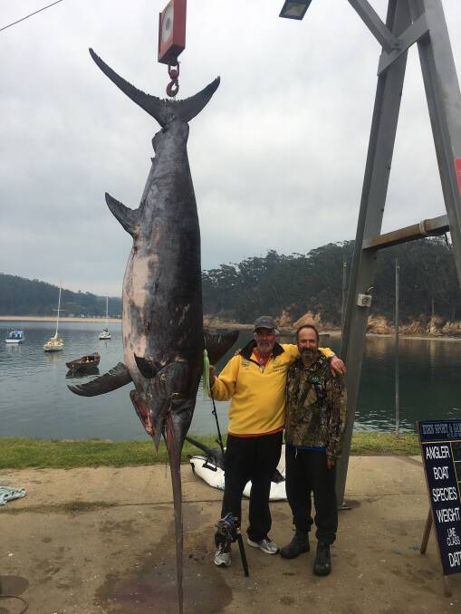 State record: Geoff McMahon and Trevor Chippindale with McMahon's 254kg broadbill catch weighed in at the Quarantine Bay gantry. 