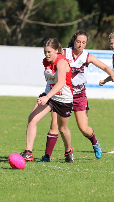 Good footwork: Eden Whaler Ally Crowe moves play forward whille a Tathra player closes in for a tackle during Saturday's close women's game. 