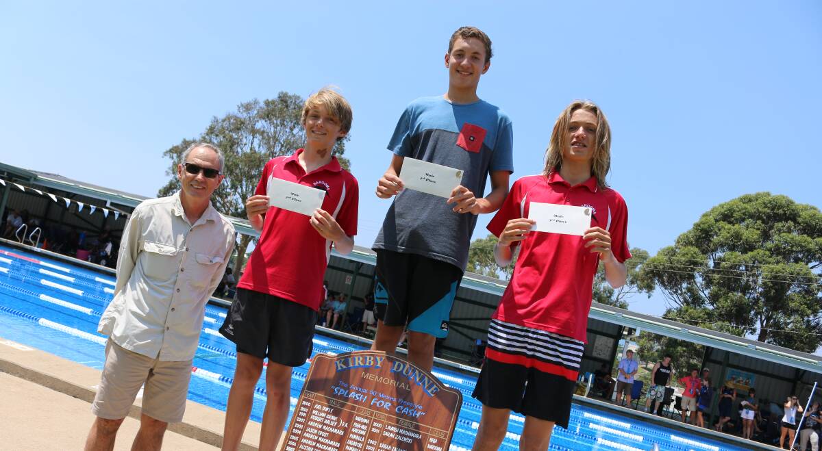 Splash for cash: Kye Moore (centre) winner of the Kirby Dunne memorial swim with Russell Dunne and the Bates brothers of Narooma, who finished second and third. 