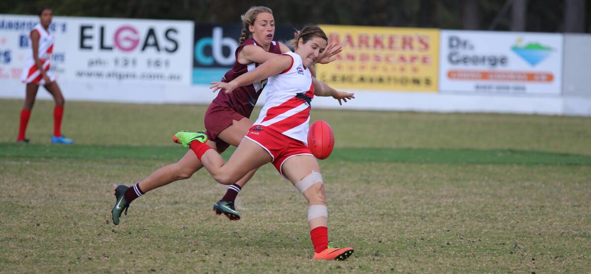 Midfield hussle: Kamilla Grubesic gets a kick away before Tathra's Tarni Evans can close the gap during Saturday's contest. 