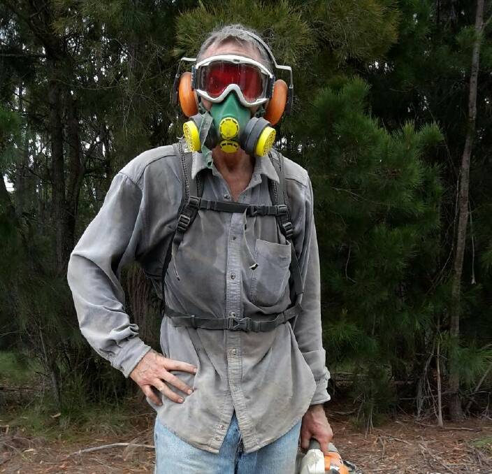 Quirky outfit: An Enduro volunteer kitted out in goggles and face mask to help clear bike trails in Tathra ahead of the pinnacle event last week. 