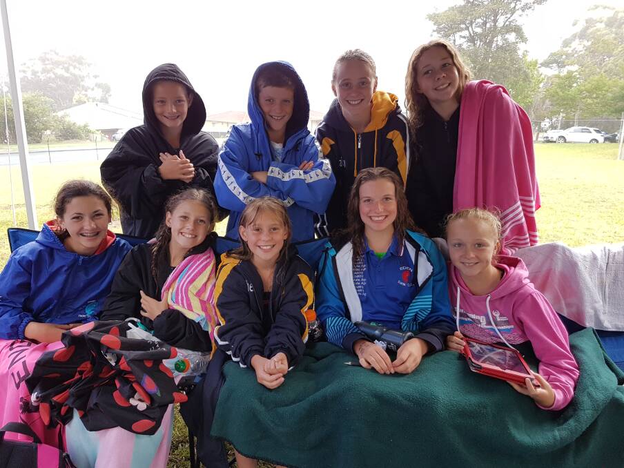 A bit chilly: Eden swimmers huddle for warmth during the SESA championship and Speedo Sprints round in Ulladulla recently where the team finished eighth overall.