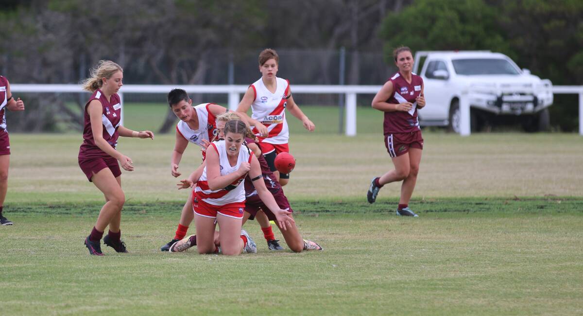 Clear it out: Ally Crowe clears the ball out of a tussle for possession with Tathra recently. The two clubs will meet in a top-of-the-table clash. 