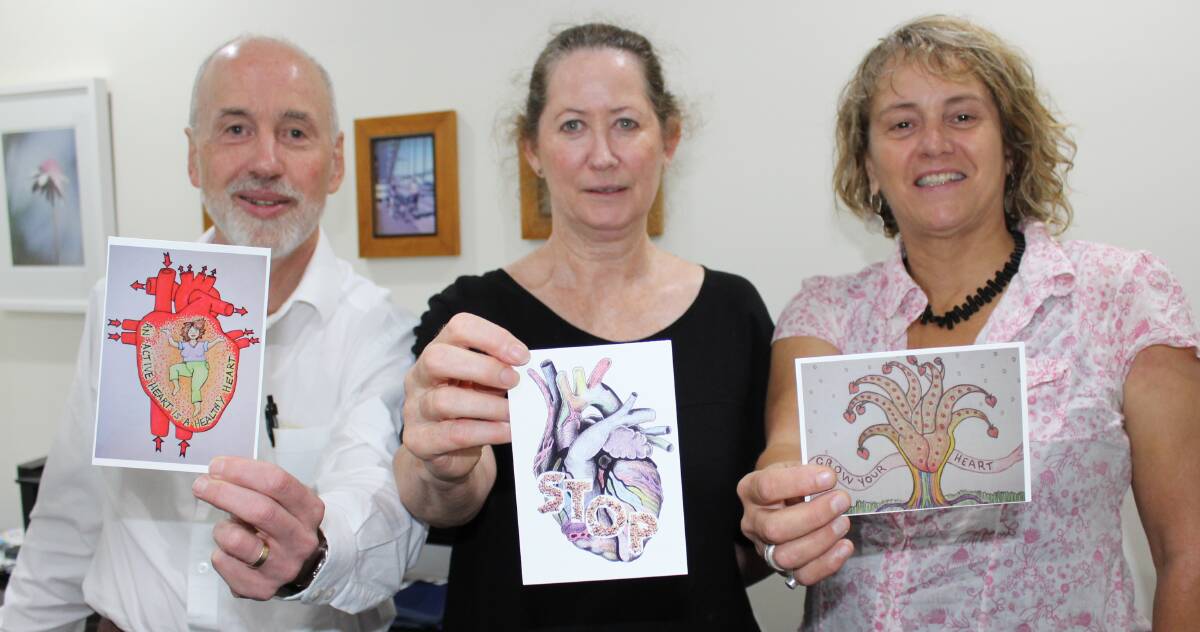 RAISING AWARENESS: Holding 'Go RED for Women' awareness postcards are Sapphire Coast Medical Practice general practitioner Dr Mark Oakley, Southern NSW Local Health District women's health nurse Ngaire Gordon and Women's Resource Centre coordinator Gabrielle Powell.
