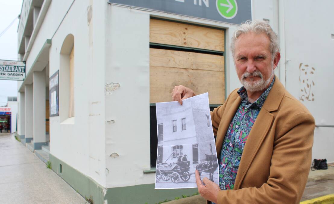 VISION: Eden’s Australasia president Peter Whiter holds a copy of a 1910 photo depicting the corner door of the old hotel. Photo: Liz Tickner.