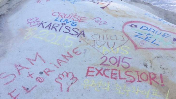 As more people have visited the site, a trend has emerged of leaving messages on the rock in coloured chalk. Photo: Supplied
