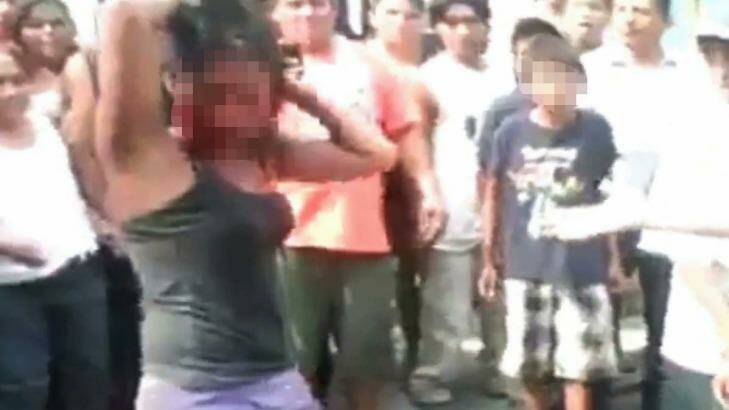 The mob surrounds the Guatemalan girl before she is set alight. Photo: YouTube