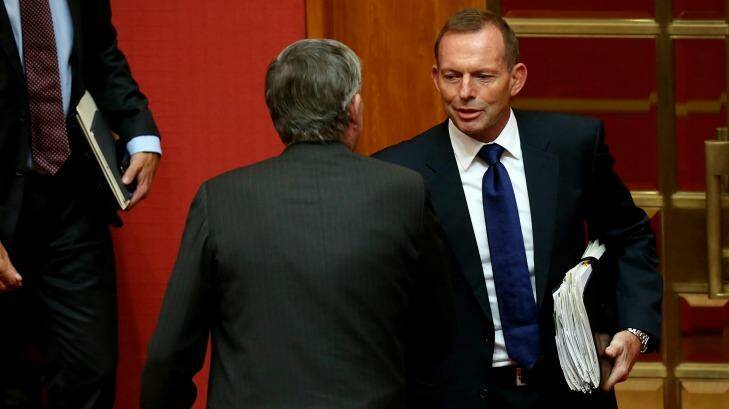 Former prime minister Tony Abbott congratulates Senator Bill Heffernan after the Senator delivered his valedictory speech earlier on Wednesday. Photo: Alex Ellinghausen