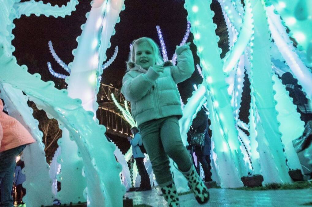 Three-year-old Liddia Vlahos, runs through the lighting installations at on the opening night of Vivid in Sydney.  Photo: Cole Bennetts