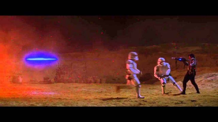 Kylo Ren uses the force to stop a blaster beam before it can hit him in <i>Star Wars: The Force Awakens</i>.
