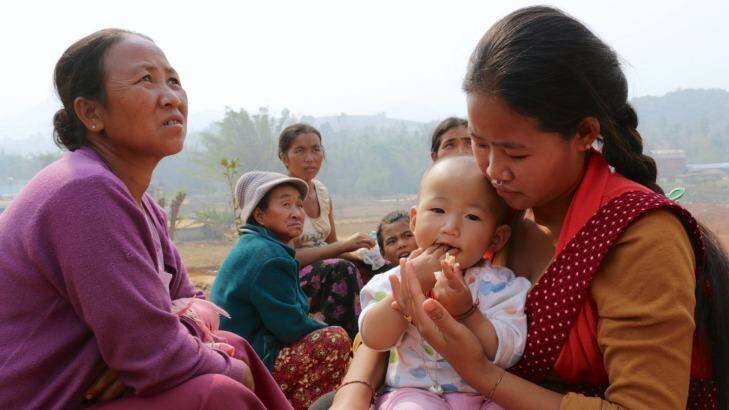 'We don't even know which side he's fighting on': Jin Ernan (right) and her 11-month-old daughter with other women at a refugee camp  in Yunnan Province. Photo: Sanghee Liu