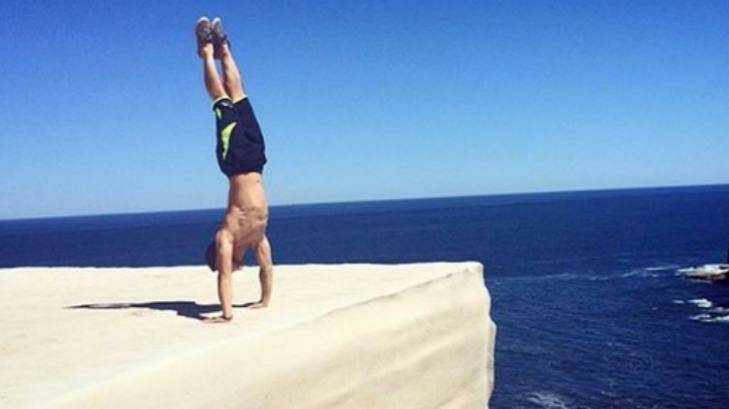 If performing a handstand on Wedding Cake Rock in Royal National Park looks dangerous, that's because it is. Photo: Instagram