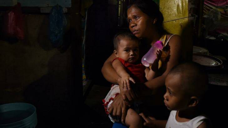 Seven-month pregnant Ruth-Jane Sombrio, widow of Rogie Sebastian, with their daughter Rogielyn (left) and son Rogie. Photo: Kate Geraghty