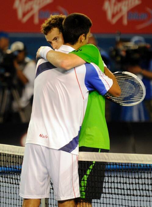 Novak Djokovic and Andy Murray embrace after the men's final in 2011. Photo: Sebastian Costanzo