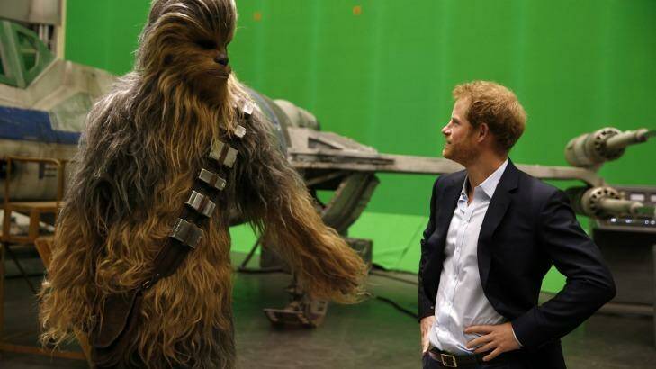 When Harry met Chewie ... Britain's Prince Harry gets some acting tips from Chewbacca during a tour of the Star Wars sets at Pinewood studios in Iver Heath, west London on April 19. Photo: Adrian Dennis