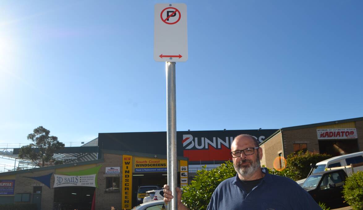 WORRYING SIGN: 3D Sails proprietor Geoff Krause with one of the No Parking signs near his business in Cranbrook Road, Batemans Bay.
