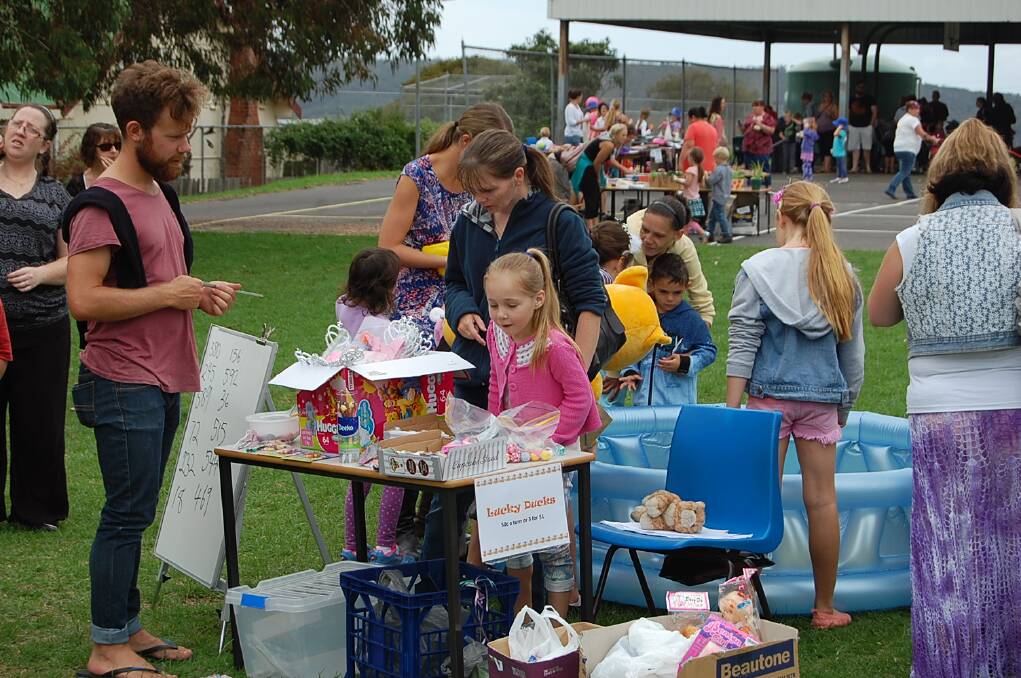 Monique Hipworth picks out a prize after scooping out a lucky duck at the Eden Public School fete on Wednesday.