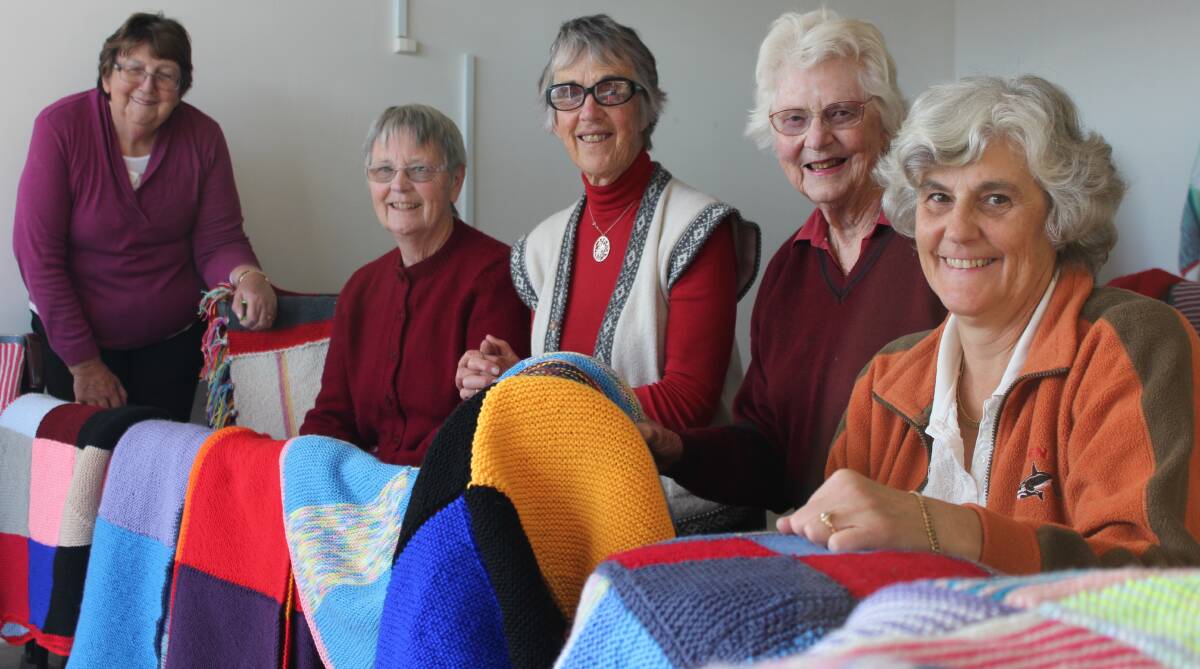 Wrap With Love knitters (from left) Valma Barber, Celia Hannan, Margaret Sheaves, Margaret Bell and Jane Adam have set up a display in the old butchers shop at Twofold Arcade, showcasing blankets that will be distributed to people in need next week.