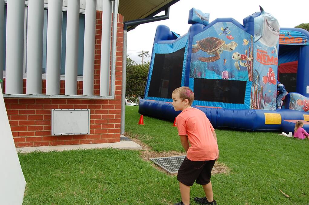 Brendan Wilson is a study of concentration as he tackles the pass-the-ball challenge at the Eden Public School fete on Wednesday.
