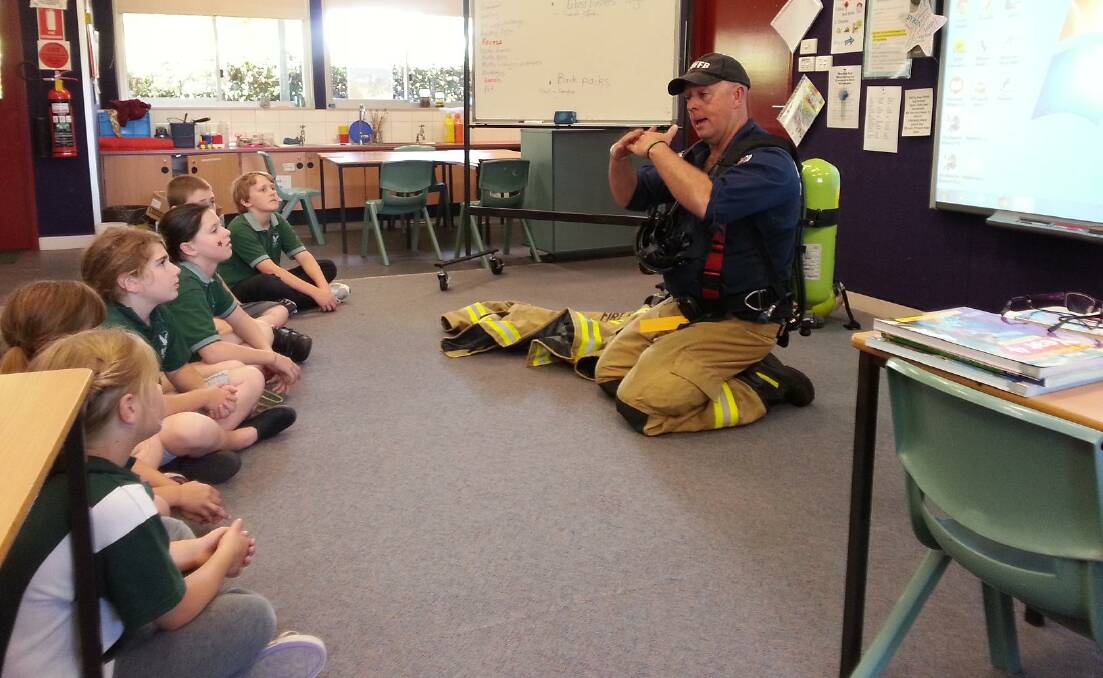NSW Fire and Rescue fire fighter Malcolm Lavender educates Wyndham Public School students on fire safety.